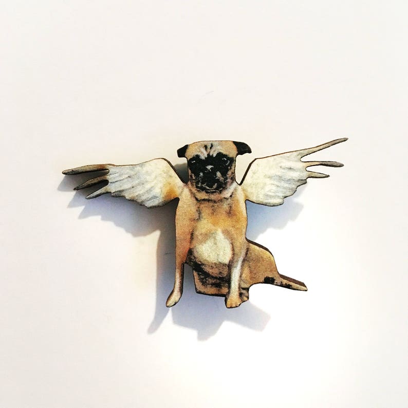 May include: A wooden figurine of a pug with wings. The pug is brown and white and has a serious expression. The wings are white and are spread out.