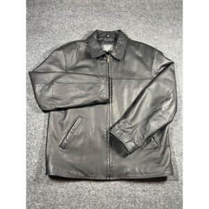 May include: A black leather jacket featuring a classic collar, a full-length front zipper closure, and two slanted side pockets. The jacket has long sleeves with straight cuffs and a smooth, matte finish across the entire exterior surface.