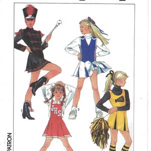 May include: Simplicity pattern featuring illustrations of four different costumes. One is a marching band uniform, and the others are cheerleading outfits. The pattern includes a size 14. The costumes are in black, red, white, and yellow.