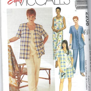 May include: A McCall's sewing pattern featuring women's clothing designs. The cover showcases various outfits, including a plaid jacket and shorts set, a floral jumpsuit, and a denim pantsuit. The text "Womanstyle" is visible.