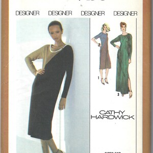 May include: Simplicity sewing pattern number 9135 for a dress. The pattern is designed by Cathy Hardwick and is sized for stretch knits only. The pattern includes three different dress styles, one with a brown and black color scheme, one with a black and tan color scheme, and one with a green color scheme. The pattern is for size 14 miss.