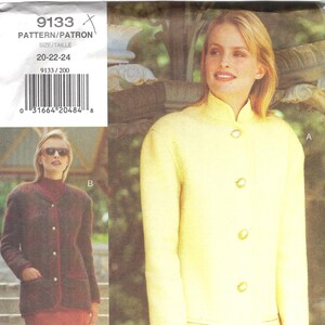 May include: A vintage sewing pattern featuring two jacket designs. One jacket is a pale yellow with a mandarin collar and gold buttons. The other is a dark brown with red trim and buttons. The pattern number is 9133, with sizes 20-22-24.