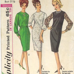 May include: Vintage Simplicity sewing pattern featuring three dress designs. The pattern includes a green dress with a belt, a white lace dress, and a black dress with lace sleeves. The pattern is for a Junior size 11 with a 31.5-inch bust.