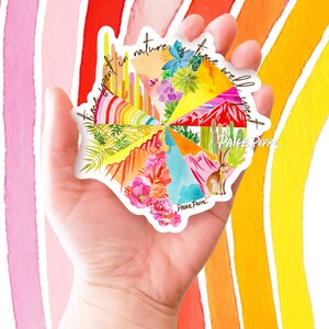 May include: A colorful sticker with a watercolor design of various landscapes and the text "Time spent in nature is time well spent Paige Poppe".