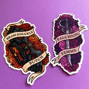 May include: Two stickers with floral designs and text. The first sticker features a brass knuckle with the text "BRASS KNUCKLE" and "BUTCH". The second sticker features a sword with the text "FALCHION" and "FEMME".