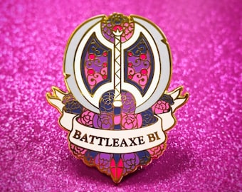 May include: A gold-colored enamel pin with a white background. The pin features a double-headed axe with a pink, purple, and blue design. The axe is surrounded by pink and purple flowers. The text "BATTLEAXE BI" is written on a white banner.