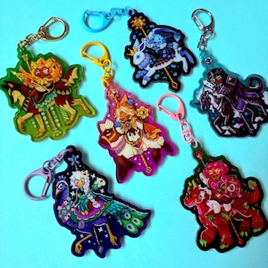 May include: A selection of colourful acrylic keychains showcasing fantasy characters on animals. Each keychain has a unique design with vibrant colours and metal hardware for easy attachment. These keychains are suitable for personal use or as gifts.