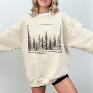 May include: A beige sweatshirt with a black and white graphic of a forest with the text "but the monsters turned out to be just trees".