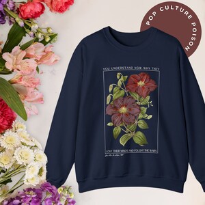 May include: Navy blue sweatshirt with a floral graphic and the text "YOU UNDERSTAND NOW WHY THEY LOST THEIR MINDS AND FOUGHT THE WARS".