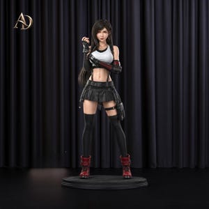 May include: A standing female character figurine with long dark hair, wearing a white sleeveless top, a black pleated skirt, black thigh-high socks, and red boots. The figure has black arm guards and a black belt with straps around the waist.