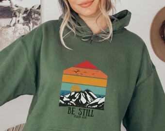 Sudadera con capucha cristiana "Be Still" y sudadera retro con estampado de montañas y atardeceres.