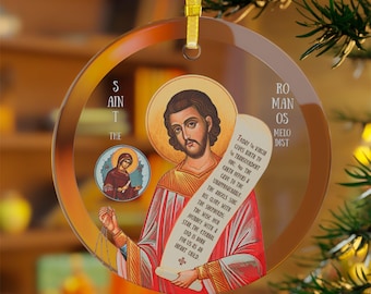 以下が含まれることがあります： 丸いクリスマスオーナメント。光輪のある男性の宗教的なアイコンが巻物を持ち、英語のテキストと女性の小さな画像が描かれています。金色のトリムと吊り下げ用の金色のリボンが付いています。