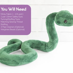 May include: A green plush snake toy with black safety eyes. The snake is curled up in a 'S' shape. The text 'You Will Need' is written in purple on a pink background. The text lists the materials needed to make the snake toy, including minky fabric, safety eyes, turning/stuffing tools, sewing thread, stuffing, pipe cleaners, and weighted beads.