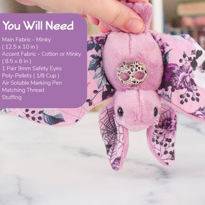 A person's hand holding a pink bat with floral details. Over it is a text box that lists the same materials needed as shown in the product description.