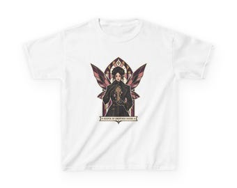 May include: A white t-shirt featuring a central graphic of a figure with dark wings holding a golden key. The design is framed by an arched window shape and includes the text "KEEPER OF UNOPENED DOORS" on a banner at the bottom.
