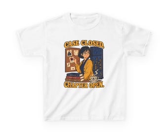 May include: A white t-shirt featuring a graphic of a person with short dark hair and glasses standing before a corkboard with pinned clues. The text CASE CLOSED, CHAPTER OPEN is printed in yellow above and below the illustration.