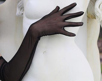 May include: A pair of black sheer long gloves with a delicate texture. The gloves are worn on a white statue of a woman.