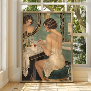 May include: A framed art print depicting a person with short dark hair wearing a cream-colored slip dress, sitting on a dark green velvet stool. The person is applying red nail polish at a marble vanity with a round mirror and teal tiles.