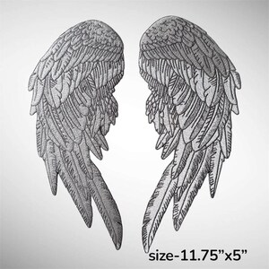 May include: A pair of embroidered silver-toned wing patches featuring detailed feather textures. The wings are positioned symmetrically, and the text size-11.75 inches by 5 inches is printed in the bottom right corner of the image.