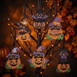 May include: Six embroidered Halloween ornaments featuring black cats and orange pumpkins. The designs include cats in purple witch hats, a cat with bat wings, and one pumpkin with the text Happy Halloween, all hanging from black ribbons.