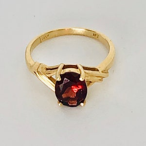 Anillo vintage de oro amarillo de 14 quilates con granate. Gema natural. Engaste de garras altas. Engaste de derivación. Artesanía.