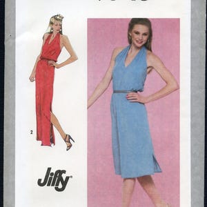May include: Simplicity sewing pattern 9546 for a Jiffy miss size 12 dress. The envelope features illustrations of a sleeveless halter-neck dress with a V-neckline, a cinched waist, and a side slit. One version is shown in red, and another in blue.