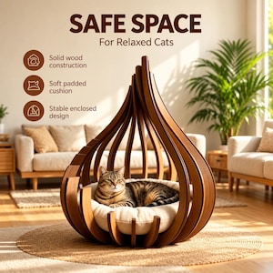 May include: A teardrop-shaped cat bed made of curved solid wood slats with a soft, round, cream-colored padded cushion inside. The text SAFE SPACE For Relaxed Cats is visible above, along with bullet points listing construction features.