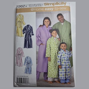 May include: A Simplicity 1562A sewing pattern envelope for robes. The cover features illustrations of four robe styles and a photograph of four people wearing robes in lavender, green, lime green polka dot, and blue diamond patterns.