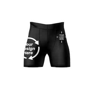 May include: Black athletic shorts featuring white text and graphics. The left side displays a circular arrow design with the text 'Your Design Here'. The right side features the text 'YOUR LOGO HERE' with four directional arrows pointing outward.