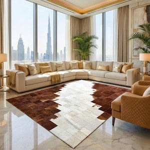 May include: A rectangular area rug featuring a patchwork design of square cowhide tiles in alternating shades of deep brown and creamy white. The rug is positioned on a polished marble floor in a room with a large sectional sofa and city view.