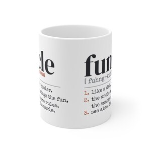 May include: A white ceramic mug featuring black and red printed text that defines the word uncle as a cooler version of a dad who brings the fun and zero rules, alongside a definition for fun with numbered list items.