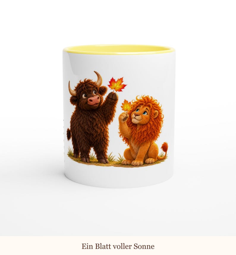 May include: A white ceramic mug with a yellow interior rim featuring a cartoon illustration of a brown highland cow and an orange lion, each holding a vibrant autumn maple leaf. The text "Ein Blatt voller Sonne" is printed below the image.