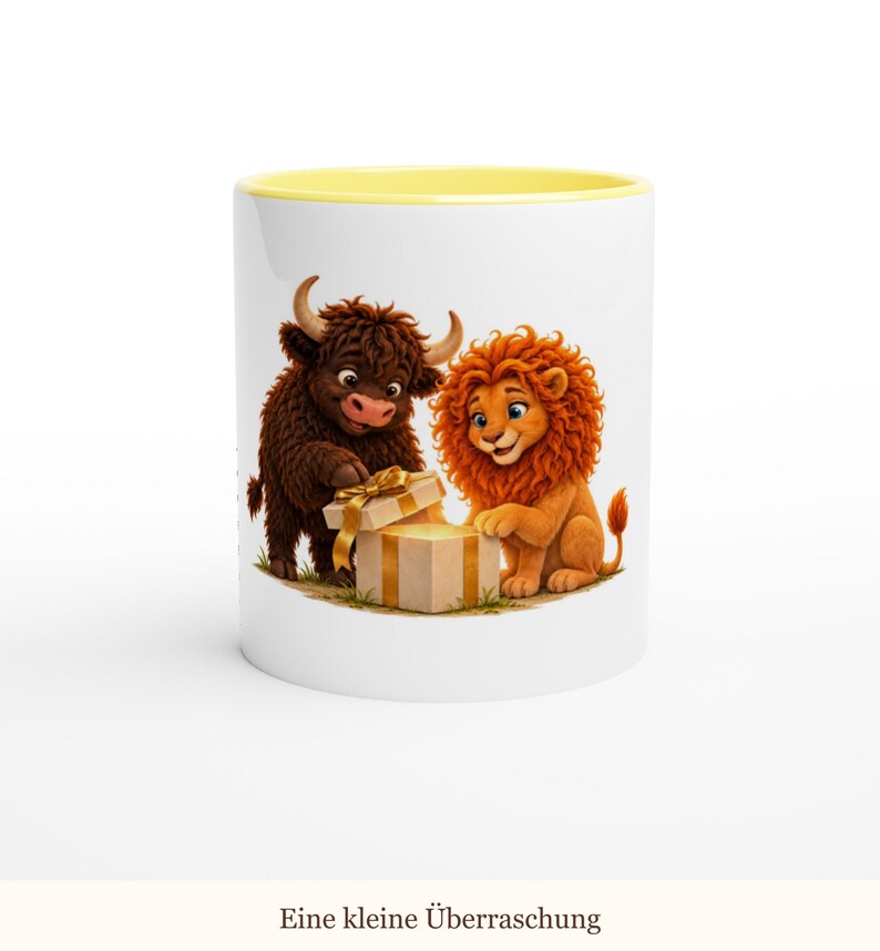May include: A white ceramic mug with a yellow interior rim featuring a graphic of a brown highland cow and an orange lion opening a beige gift box with a gold ribbon. The text "Eine kleine &Uuml;berraschung" is printed below the illustration.