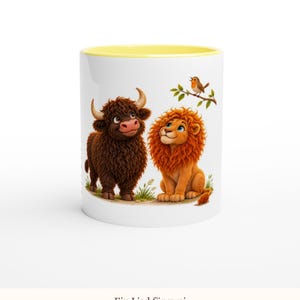 May include: A white ceramic mug with a yellow interior rim featuring a colorful illustration of a brown highland cow and an orange lion sitting together, with a small bird perched on a branch above them. The text Ein Lied f&uuml;r zwei is below.