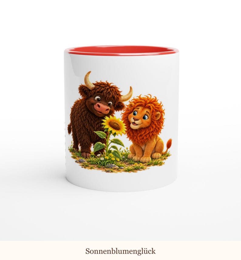 May include: A white ceramic mug with a red interior rim featuring a graphic illustration of a brown highland cow and an orange lion sitting together in a grassy field looking at a yellow sunflower with the text Sonnenblumengl&uuml;ck.