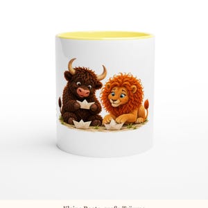 May include: A white ceramic mug with a yellow interior rim featuring a graphic of a brown highland cow and an orange lion playing with paper boats. Below the illustration, the text reads: Kleine Boote, gro&szlig;e Tr&auml;ume.