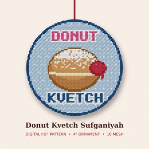 May include: A circular cross-stitch pattern featuring a brown donut with white powdered sugar, a cream filling, and a red jelly dollop. The text DONUT is in pink and KVETCH is in dark blue. Below, the text reads Donut Kvetch Sufganiyah DIGITAL PDF PATTERN 4" ORNAMENT 18 MESH.