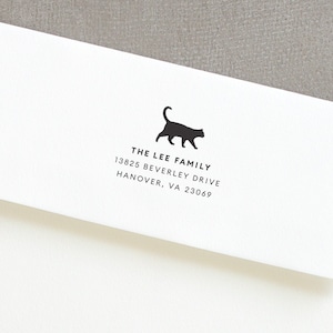 May include: White envelope with a black silhouette of a cat and the text "THE LEE FAMILY 13825 BEVERLEY DRIVE HANOVER, VA 23069"