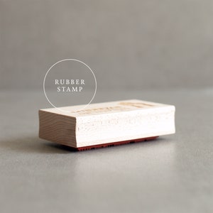 May include: A wooden rubber stamp with the text "RUBBER STAMP" in a circle above the stamp.
