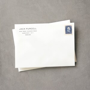 May include: White envelope with a black address label that reads "JACK PURCELL 4097 WEST PINHOOK ROAD GARDINER - M.T. 59030". A blue postage stamp with a portrait of George Washington is in the upper right corner.