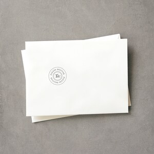 May include: A white envelope with a round, black stamp that says "Please Deliver To: Please Deliver".