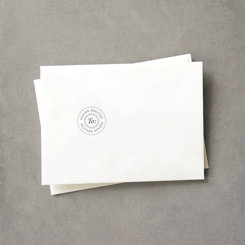 May include: A white envelope with a round, black stamp that says "Please Deliver To: Please Deliver".