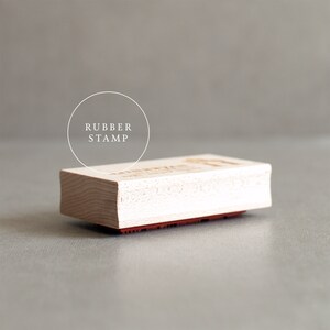 May include: A wooden rubber stamp with the text "RUBBER STAMP" in a circle above the stamp.