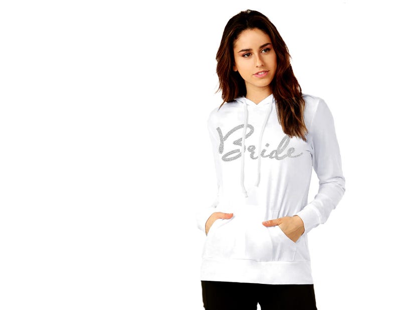 May include: White hoodie with a silver glitter 'Bride' graphic on the front.