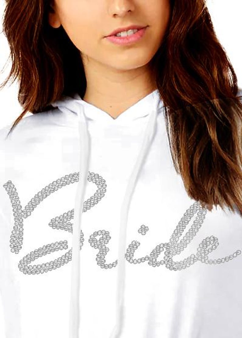 May include: White hoodie with the word "Bride" spelled out in rhinestones.
