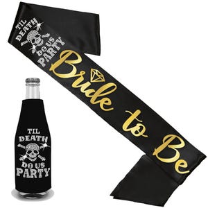 May include: A black satin sash with gold text reading Bride to Be and a diamond icon, paired with a black bottle cooler featuring a rhinestone skull and crossbones design with the text TIL DEATH DO US PARTY in white rhinestones.