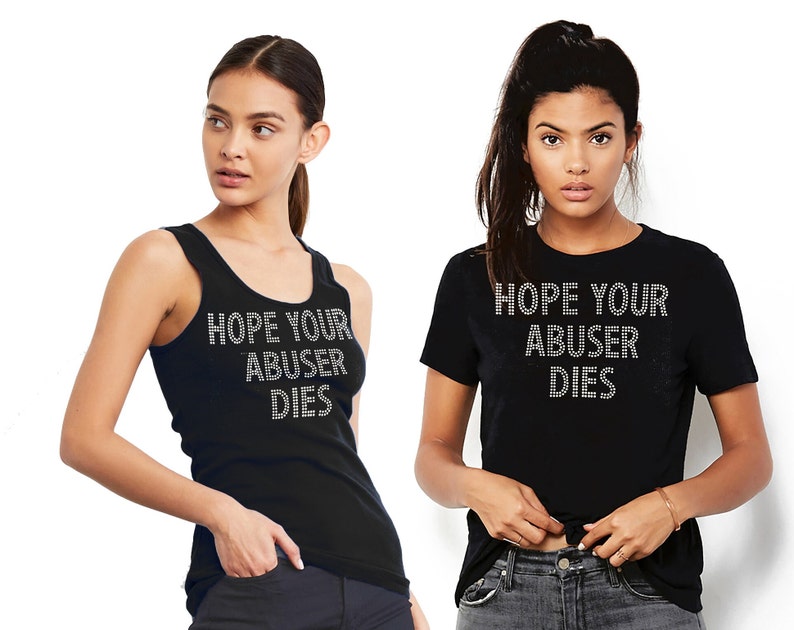 May include: A black sleeveless tank top and a black short-sleeved t-shirt, both featuring the text "HOPE YOUR ABUSER DIES" written in silver-toned rhinestones across the chest area. The garments are plain black with a simple crew neckline design.