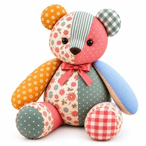 Patchwork memory bear sewing pattern inspiration featuring a handmade teddy bear with floral, striped, gingham and polka dot fabric panels, colorful patchwork body, button eyes and coral ribbon bow, isolated on a clean white background.
