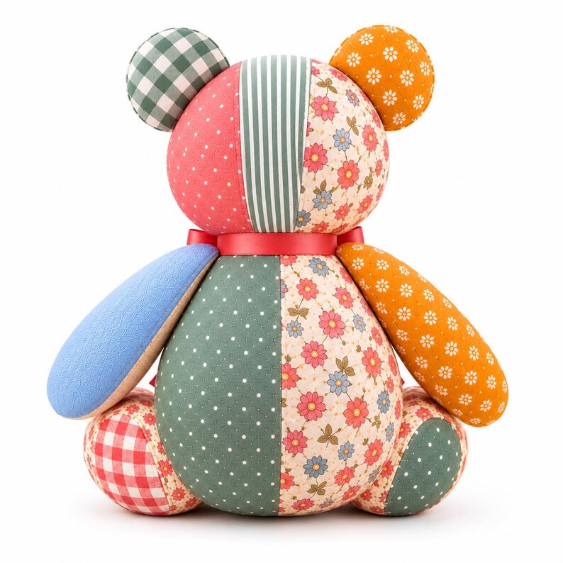 Patchwork memory bear sewing pattern back view featuring a handmade teddy bear with floral, sage green polka dot, striped, gingham and mustard flower-print fabric panels, stitched seams and a coral ribbon collar, isolated on a clean white background.