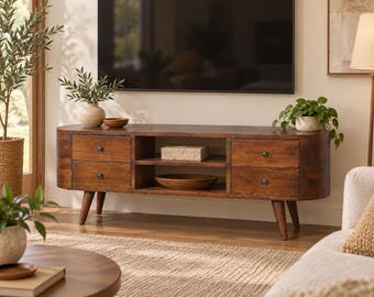 May include: A long, dark wood media console with rounded edges, featuring four drawers with small dark knobs and two open center shelves. The unit is supported by four tapered legs and has a smooth, polished finish throughout the structure.